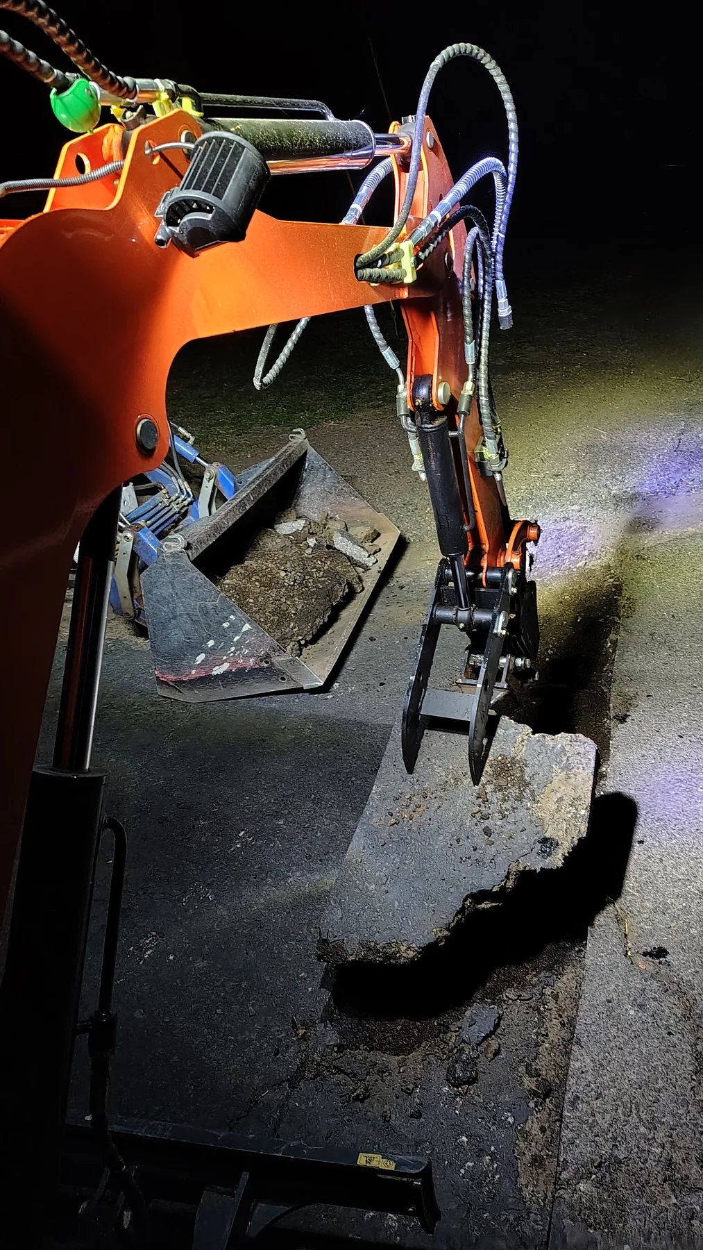 Excavator working among rocks at Rogue Rapid Farms in the evening