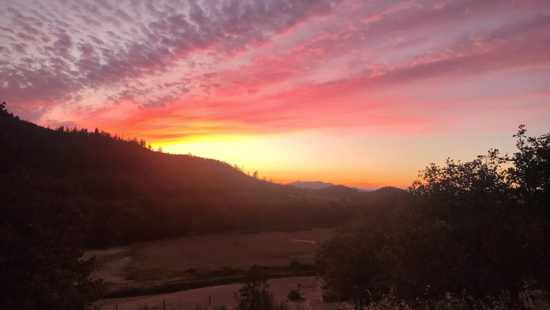 October sunset clouds over the fields and ridge at Rogue Rapid Farms